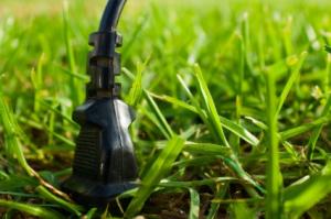 Electrical plug in a field of grass