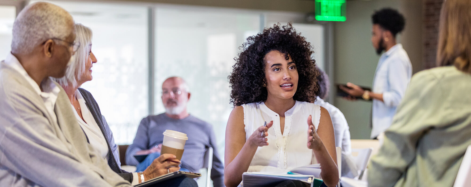  A Black woman gesturing and explaining things to a crowd