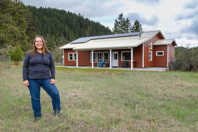 Woman standing in front of a house