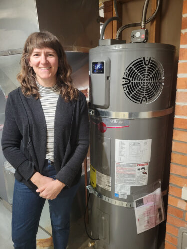 Woman standing in front of a water heater