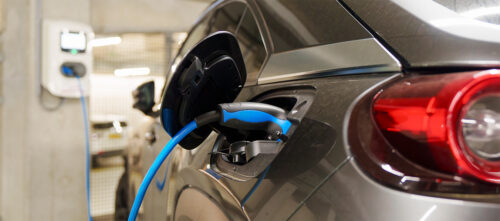 An electric vehicle charging in a parking garage