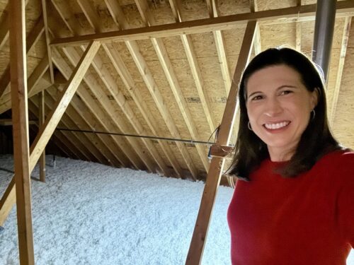 Woman standing in front of insulation