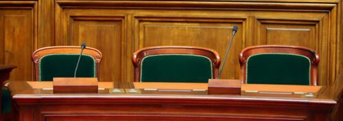Empty vintage court's room with table,chairs and microphones.