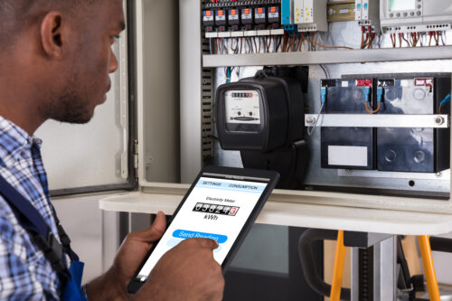 Male Technician Doing Meter Reading Using Tablet