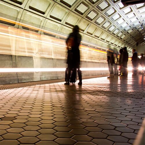 A motion blur of a subway train passing and then departing from Union Station in Washington, DC.